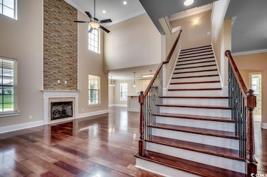 Stairs with ceiling fan, hardwood / wood-style flo