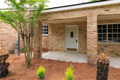 View of exterior entry with brick siding