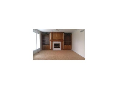 Great room with built-ins and wall of windows