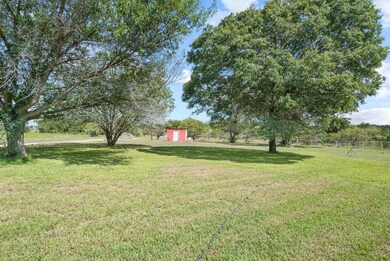 View of yard with a storage unit