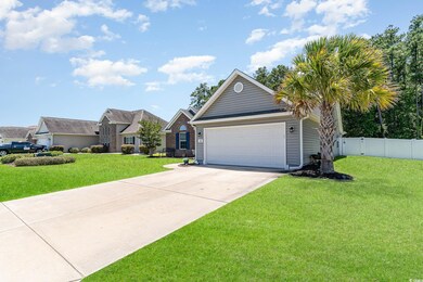 Single story home featuring a front lawn and a gar