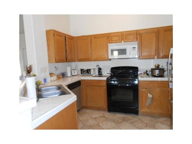 Property Photo. Kitchen has tile flooring and coun