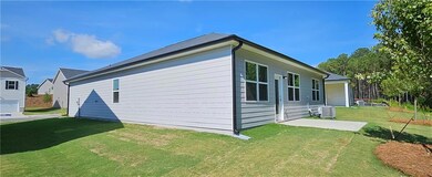 View of side of home with a yard and central AC un