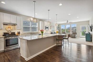 Stunning kitchen with 12.5 ft granite island, white-painted maple cabinets, and whirlpool SS appliances
