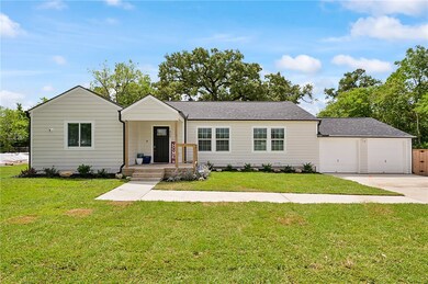 Ranch-style home with a front yard and a garage
