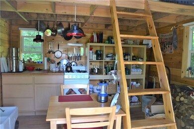 Kitchen and Living room area of cabin.  Shelves to