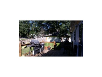 back lawn, deck view and garage view.