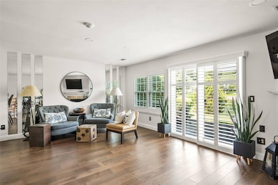 Sitting room featuring dark wood-style flooring and recessed lighting