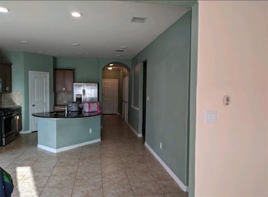 Kitchen with stainless steel appliances, arched w
