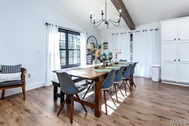 Dining space featuring light wood-style floors and a chandelier