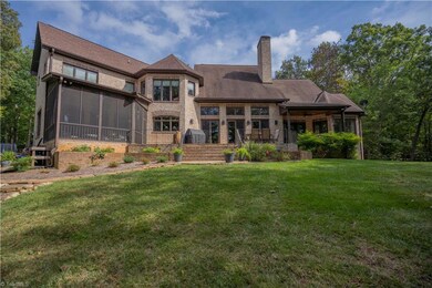 Lakeside showing screened porch off keeping room, covered deck off primary bedroom and office and open deck off great room.