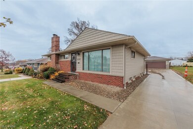 View of front of house with a front yard and a garage