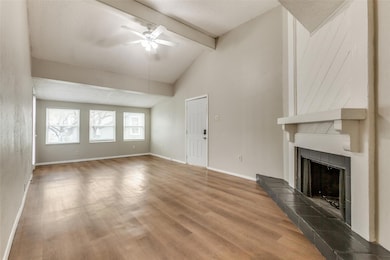 Unfurnished living room featuring a tile fireplace