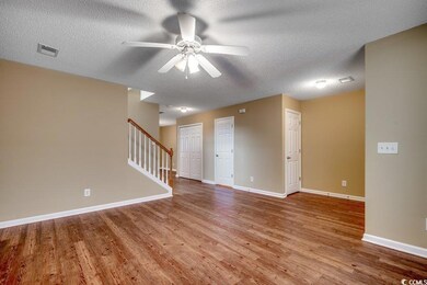 Spare room featuring visible vents, stairway, base