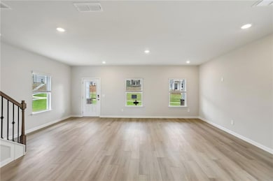 Unfurnished living room featuring light wood finis