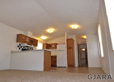 Large living room in this open concept home , vaul