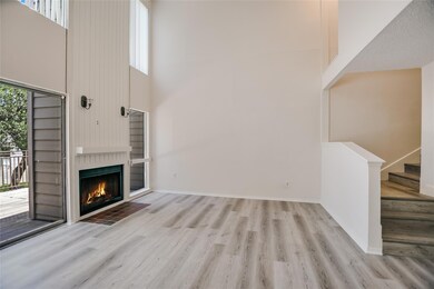 Unfurnished living room featuring a high ceiling,