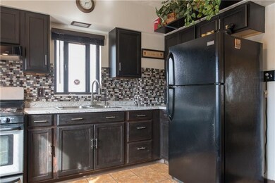 Updated kitchen with ceramic tile floor.