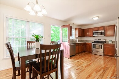 Large Eat in Kitchen features Hardwood Floors, Gra