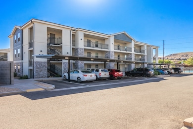 View of property featuring covered parking and stairs