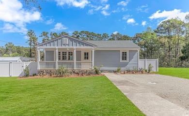 View of front of home with a porch, roof with shin