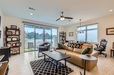 Living room featuring ceiling fan, a chandelier, recessed lighting, and light tile patterned flooring