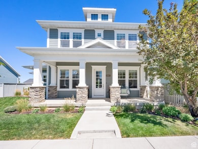 Traditional style home featuring covered porch and stone siding