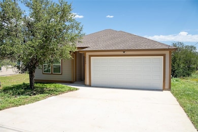 View of front of property with concrete driveway,