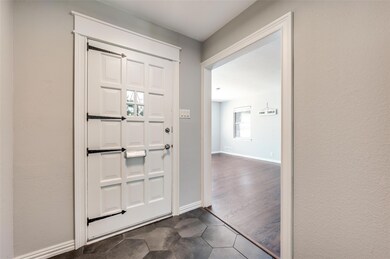 Doorway featuring dark wood-type flooring