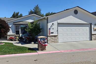 Single story home featuring concrete driveway, an attached garage, and stone siding