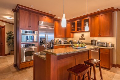Fully equipped kitchen featuring a full suite of high-end stainless-steel appliances, African mahogany cabinetry and kitchen island