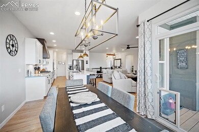 Dining space with light wood-type flooring, recessed lighting, ceiling fan, and a chandelier