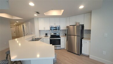 Kitchen with light countertops, a sink, appliances