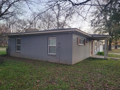 View of side of home with a lawn