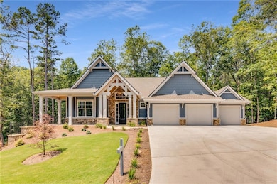Craftsman-style home with a garage and a front yar