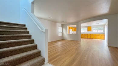 Unfurnished living room with light wood-style floors and stairway