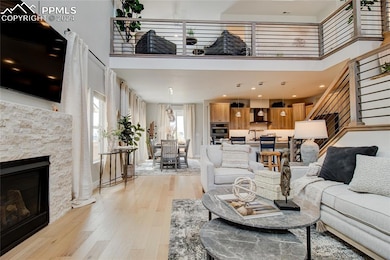Living room featuring a fireplace, light hardwood 