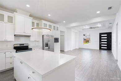 Kitchen featuring visible vents, a center island, stainless steel appliances, light countertops, and a raised ceiling