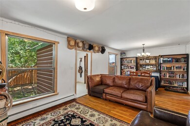 Living room with a baseboard radiator, an inviting