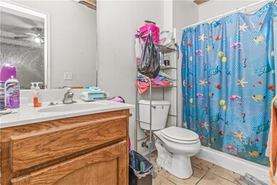 Bathroom with vanity, tile patterned floors, and toilet