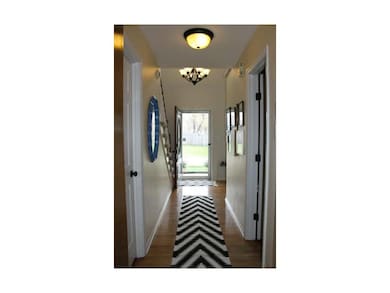 Warm and inviting front entry with beautiful hardw