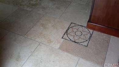 Travertine tile floors throughout makes this home 