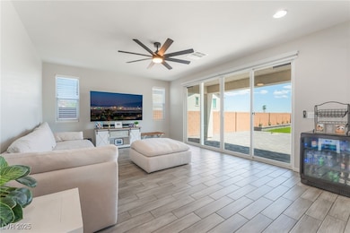 Living area featuring a ceiling fan, healthy amoun