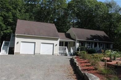Front of House with gravel driveway.