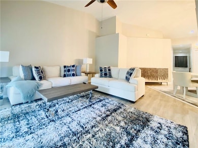 Living room with hardwood / wood-style flooring an