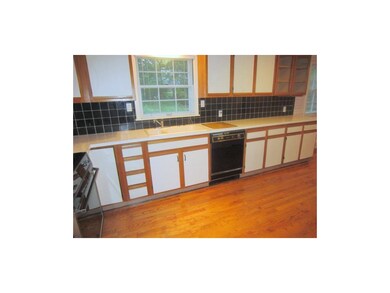 Large galley kitchen with hardwood floor