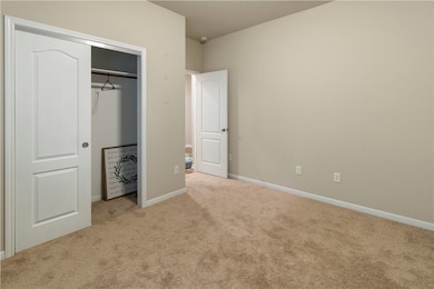 Unfurnished bedroom with carpet floors, baseboards