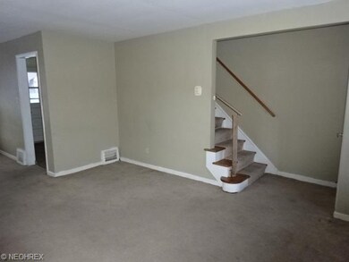 Living room is close to the stairs that lead to the second floor