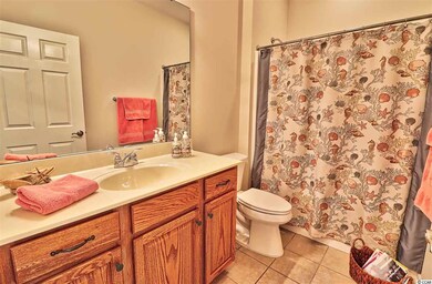 Features tub/shower combo and vanity with storage. A large linen closet is just outside.