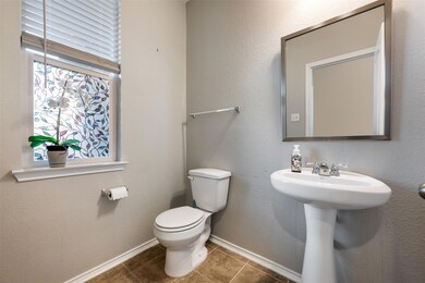 Bathroom featuring toilet and tile patterned floo